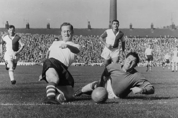 Soccer. Tom Finney, Preston North End squeezes the ball past Adam Blacklaw