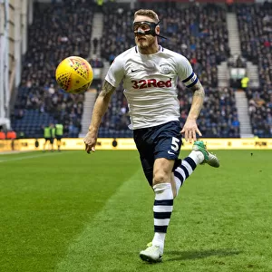 A Masked Tom Clarke Chases The Ball At Deepdale