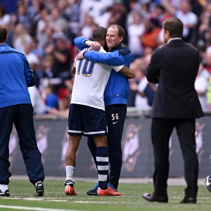 Preston North End's Jermaine Beckford Embraces Manager Simon Grayson in Euphoric Play-Off Final Victory